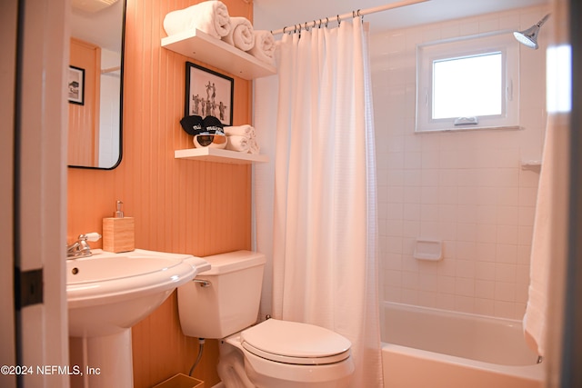 bathroom featuring wooden walls, shower / tub combo, and toilet