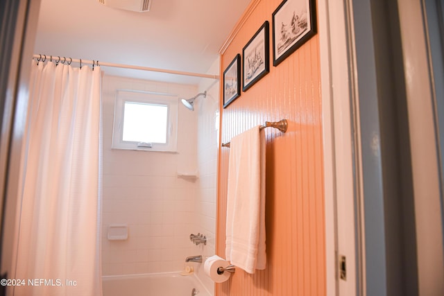 bathroom with shower / bath combo with shower curtain