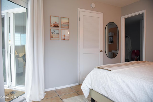 bedroom featuring light tile patterned floors and a closet