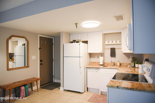 kitchen featuring white cabinets, white appliances, sink, and light tile patterned floors