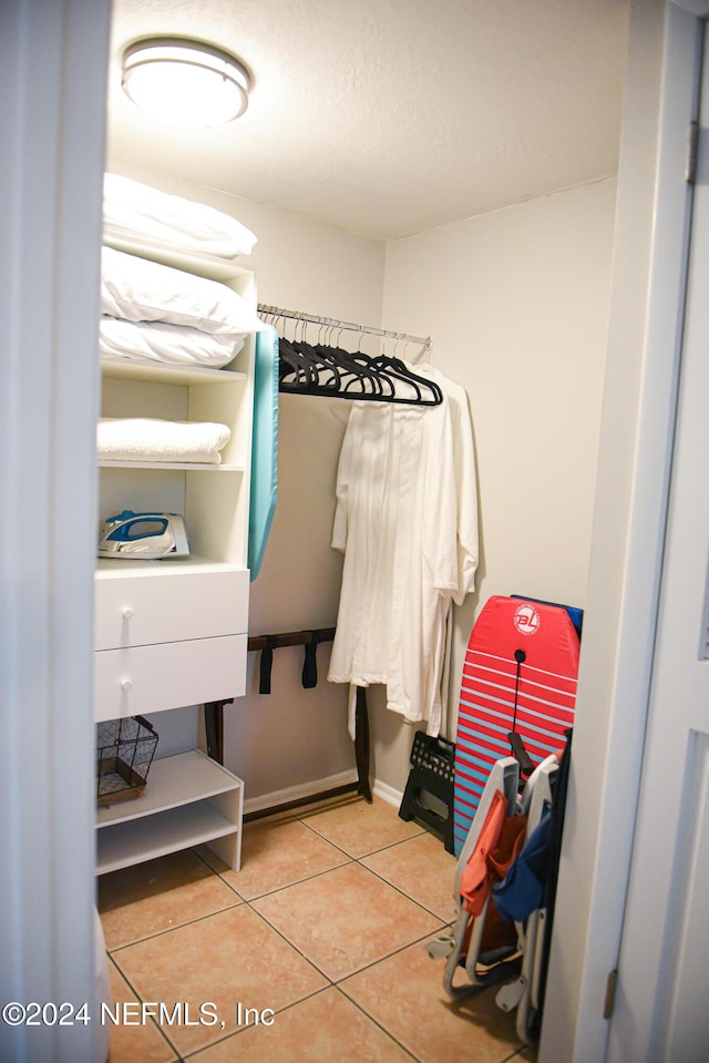 walk in closet featuring tile patterned flooring