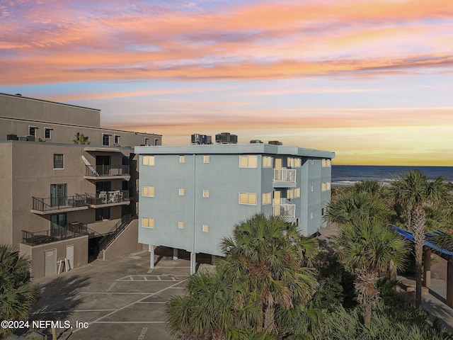 outdoor building at dusk featuring a water view