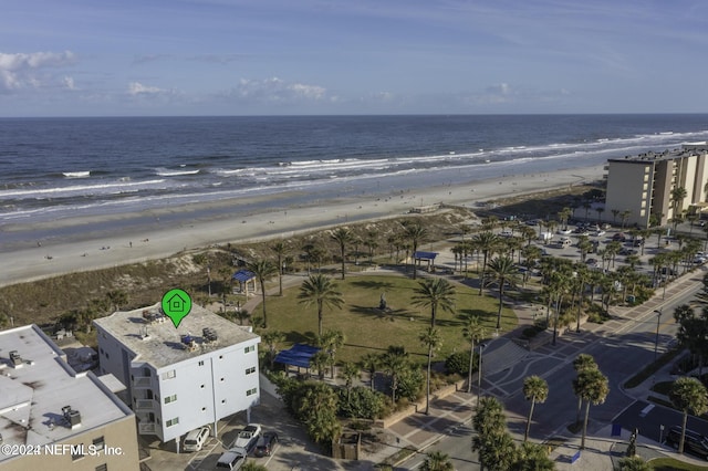 birds eye view of property featuring a water view and a beach view