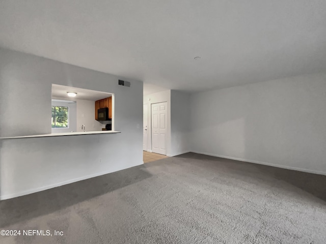 unfurnished living room with light carpet