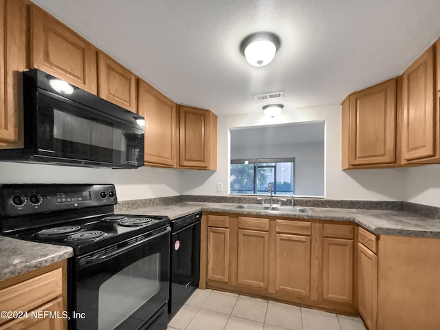 8849 Old Kings Rd S Unit 181, Jacksonville, FL 32257 - kitchen with black appliances, light tile patterned flooring, and dark countertops