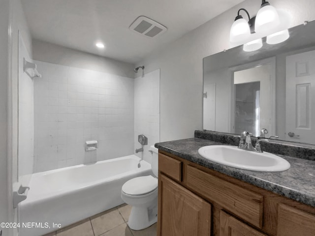 full bathroom featuring tile patterned flooring, vanity, tiled shower / bath combo, and toilet