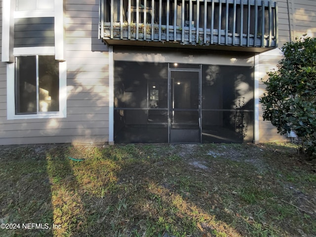 view of property exterior featuring a sunroom and a balcony