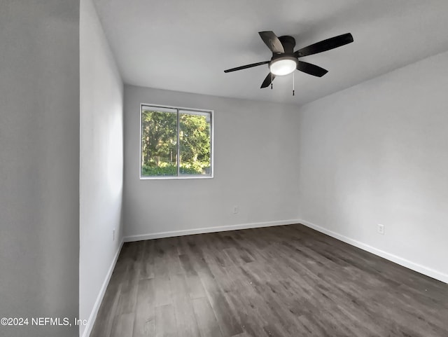 empty room featuring dark hardwood / wood-style flooring and ceiling fan