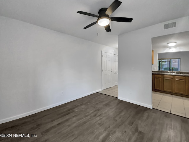 spare room featuring ceiling fan and light wood-type flooring