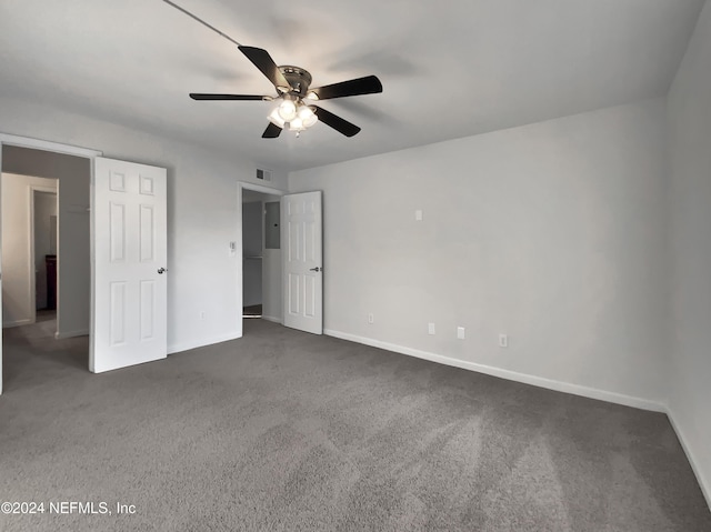 unfurnished bedroom featuring dark colored carpet and ceiling fan