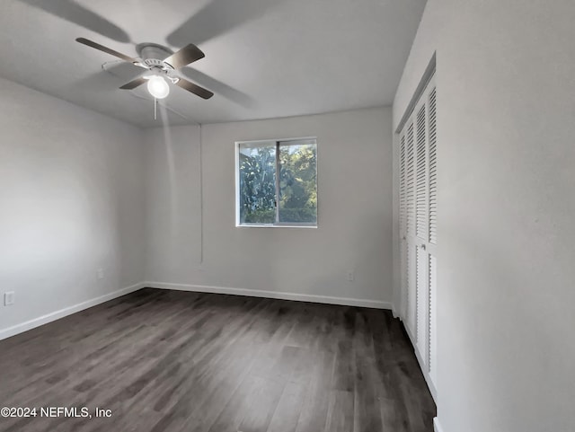 unfurnished bedroom featuring a closet, ceiling fan, and dark hardwood / wood-style flooring