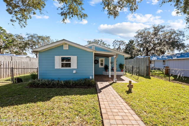 bungalow-style home with a front yard