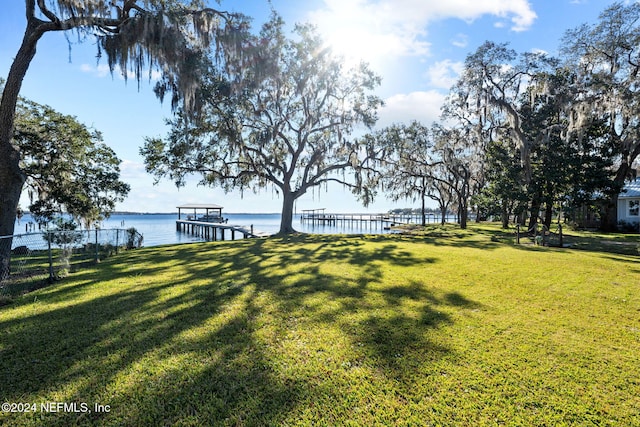 view of yard featuring a boat dock and a water view