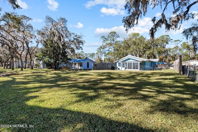 view of yard with a sunroom