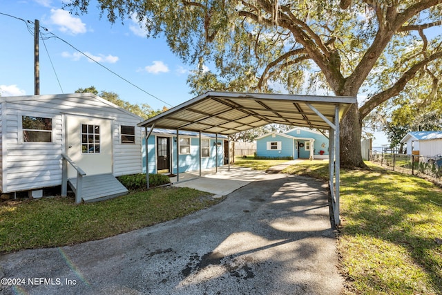 view of car parking featuring a lawn and a carport