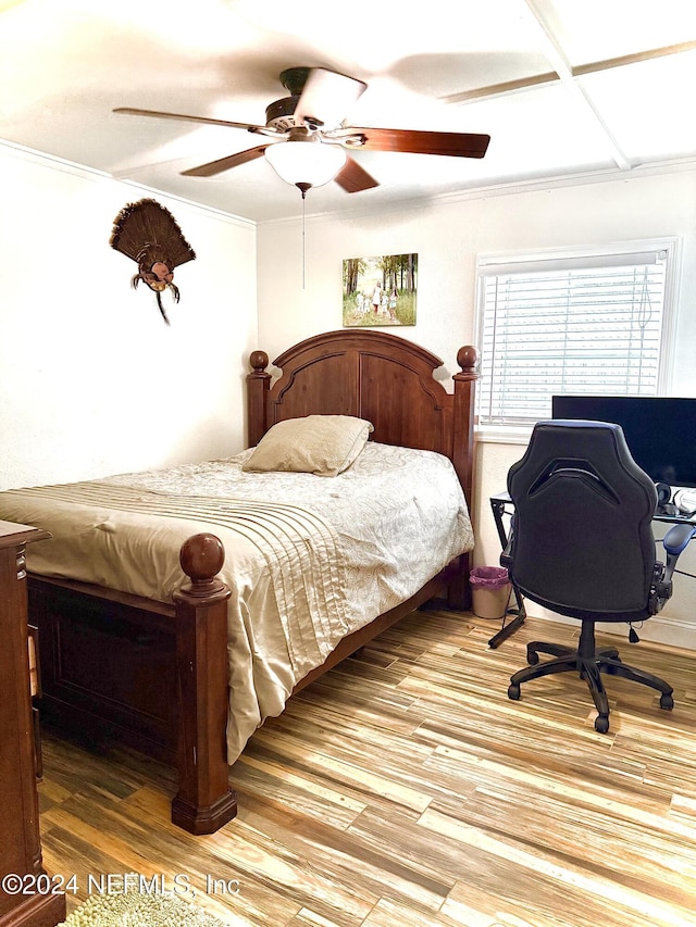 bedroom with wood-type flooring, ceiling fan, and crown molding