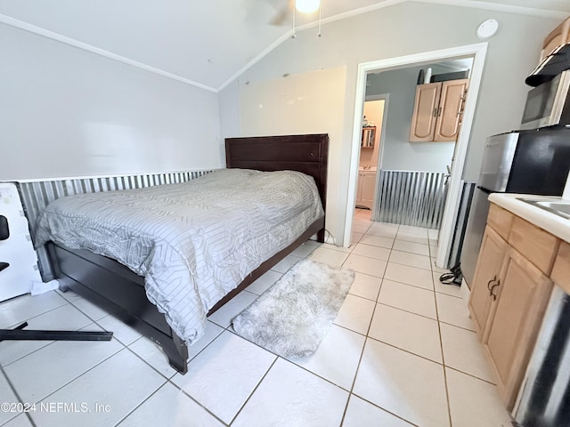 tiled bedroom with lofted ceiling and connected bathroom