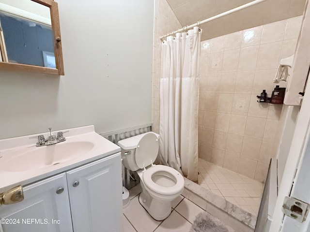 bathroom featuring toilet, vanity, tile patterned floors, and walk in shower