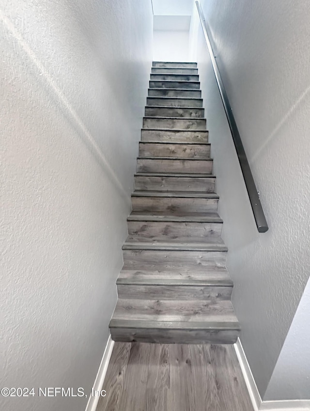 stairs with hardwood / wood-style flooring