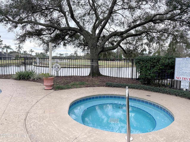 view of swimming pool featuring a water view