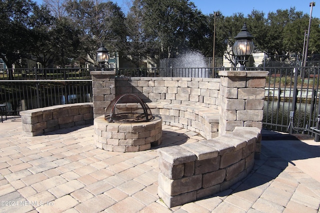 view of patio / terrace featuring a water view and an outdoor fire pit