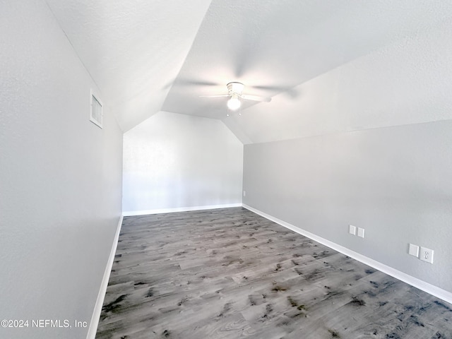 bonus room featuring hardwood / wood-style floors, a textured ceiling, vaulted ceiling, and ceiling fan