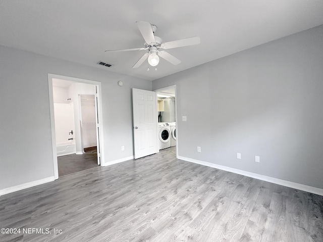 unfurnished bedroom with light hardwood / wood-style floors, ceiling fan, and washing machine and clothes dryer