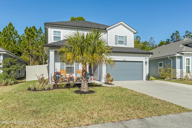 view of front of house featuring a garage and a front lawn