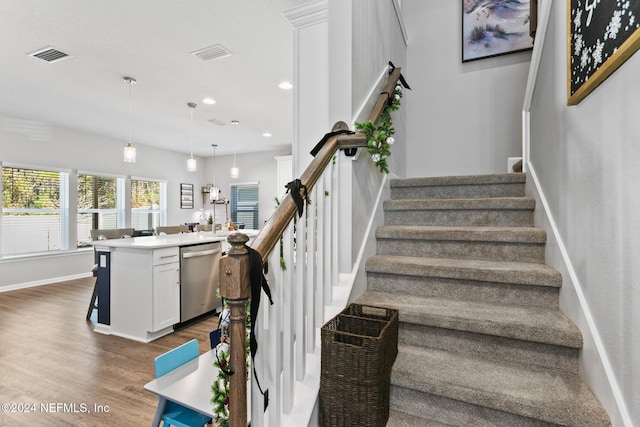 staircase with wood-type flooring