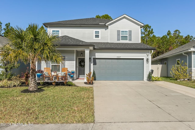 front of property featuring a front lawn and a garage