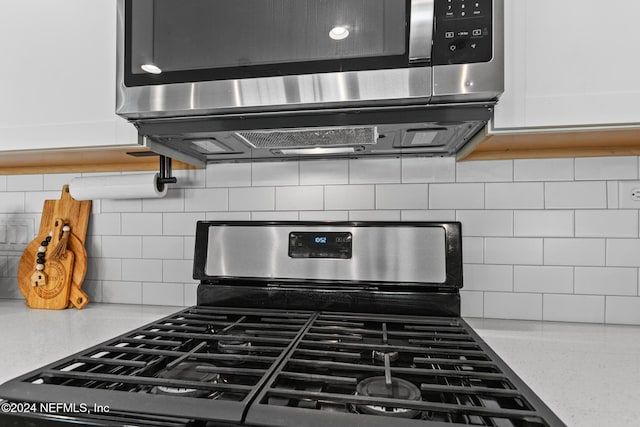 room details with white cabinetry, appliances with stainless steel finishes, and tasteful backsplash