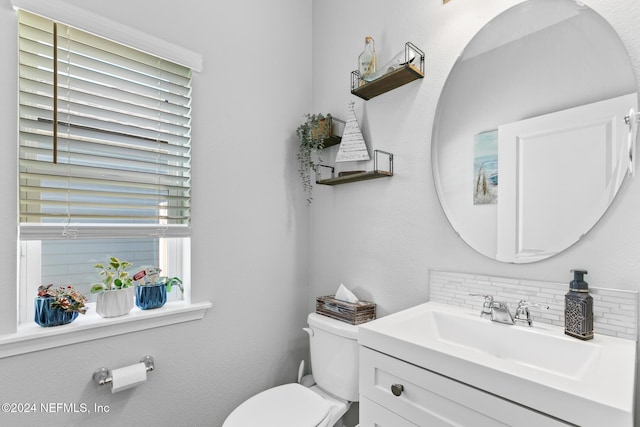 bathroom featuring decorative backsplash, vanity, and toilet