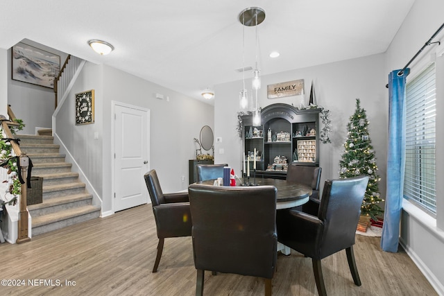 dining space with wood-type flooring