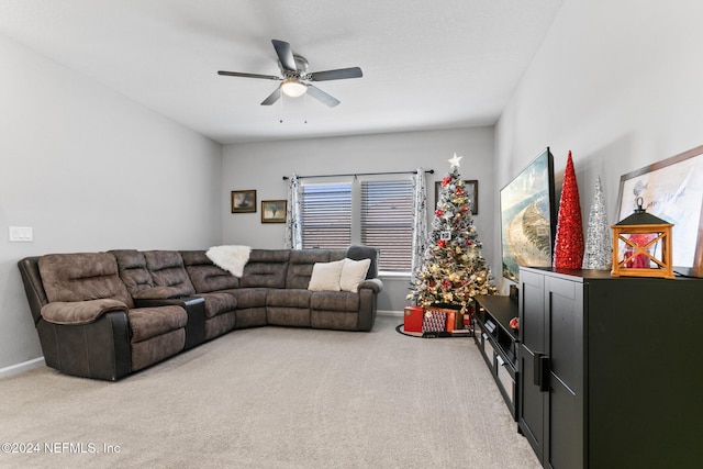 carpeted living room with ceiling fan