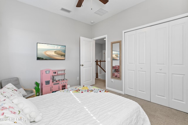 carpeted bedroom featuring ceiling fan and a closet