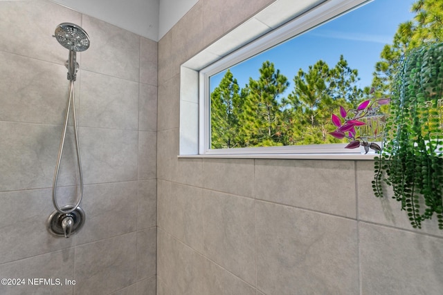 interior details featuring a tile shower