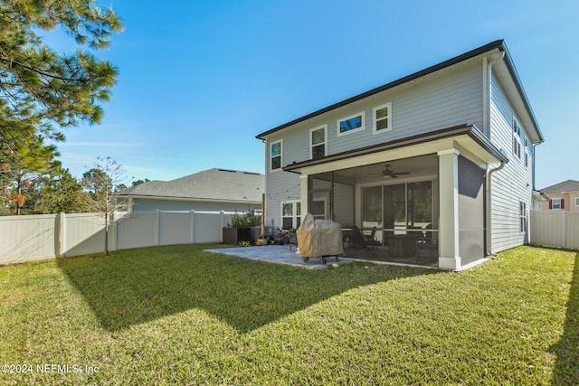 rear view of house featuring a sunroom, ceiling fan, and a yard