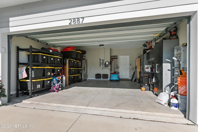 garage with electric panel and a garage door opener