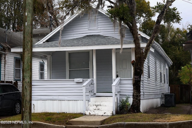 bungalow with a porch and cooling unit