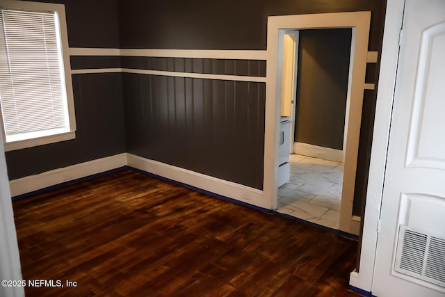 empty room with dark wood-type flooring