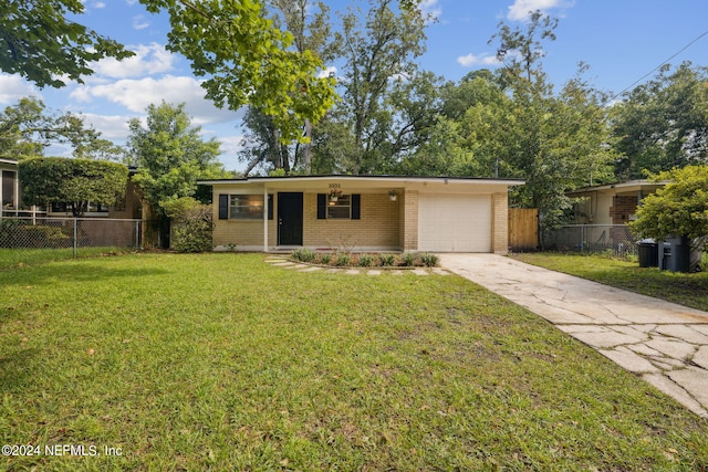 single story home with a front yard and a garage