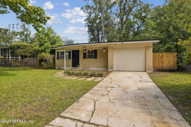 single story home with a garage and a front lawn