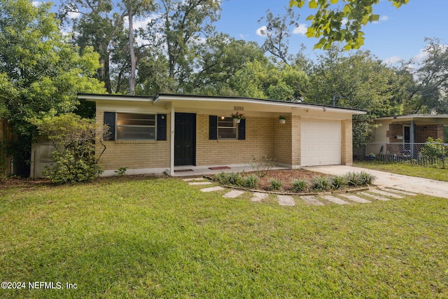 ranch-style house featuring a front lawn, a carport, and a garage