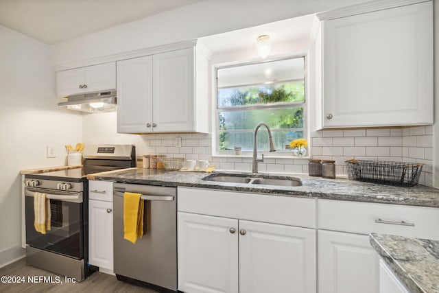 kitchen with backsplash, white cabinetry, sink, and appliances with stainless steel finishes