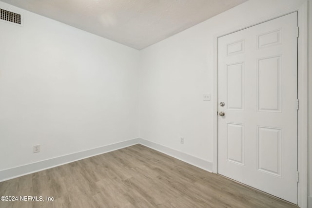 empty room with light hardwood / wood-style flooring