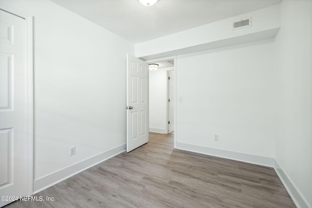 unfurnished room with light hardwood / wood-style flooring