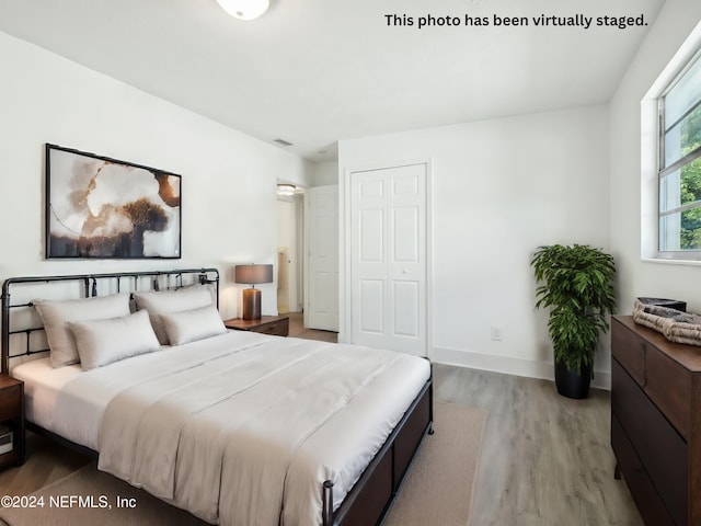 bedroom featuring a closet and light hardwood / wood-style flooring