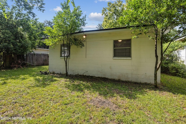 view of property exterior featuring a lawn