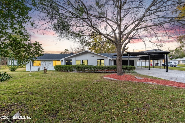 single story home with a carport and a lawn