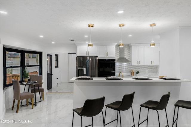 kitchen with white cabinetry, stainless steel fridge, double oven, and decorative light fixtures